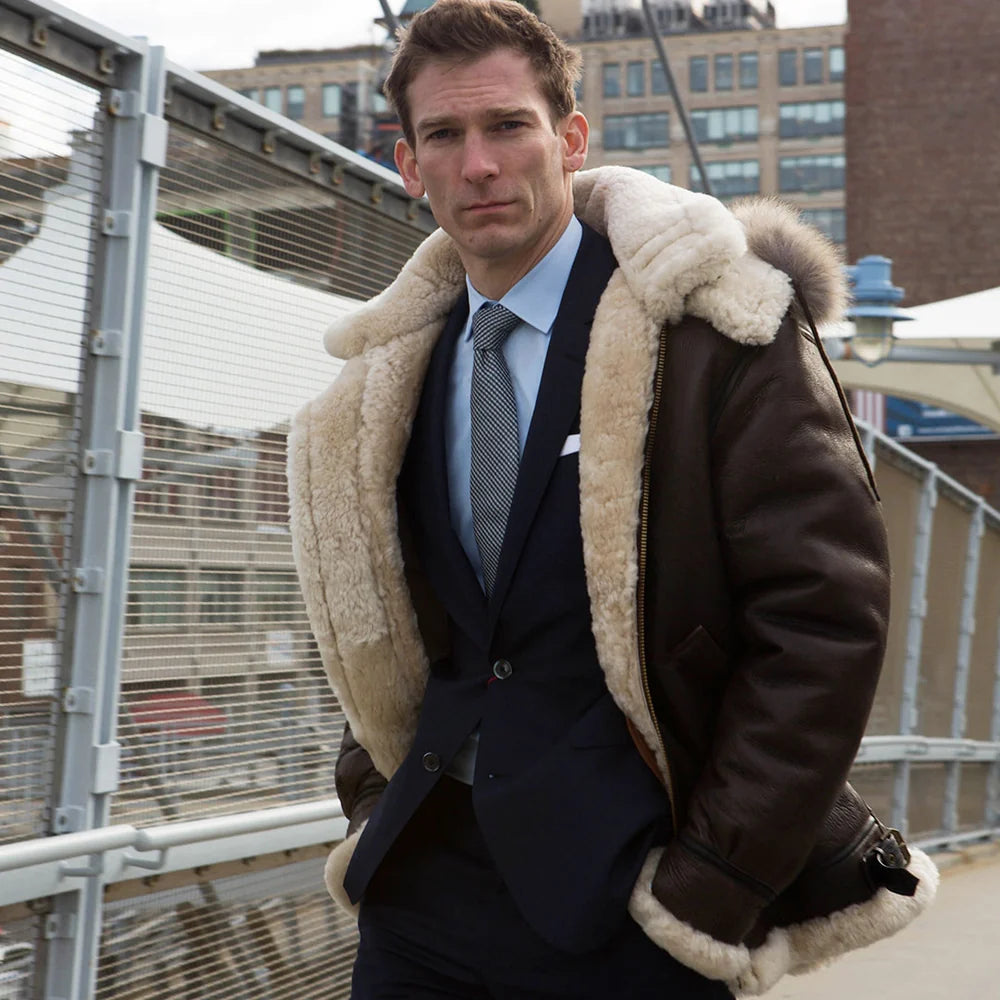 Man wearing a dark coat with a fur-lined hood in an urban setting