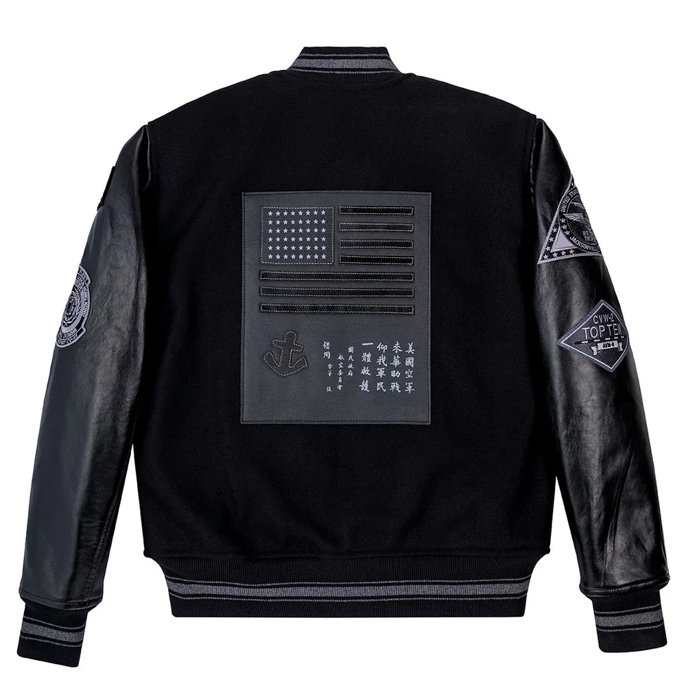 Black jacket with patches on the back and sleeves against a white background