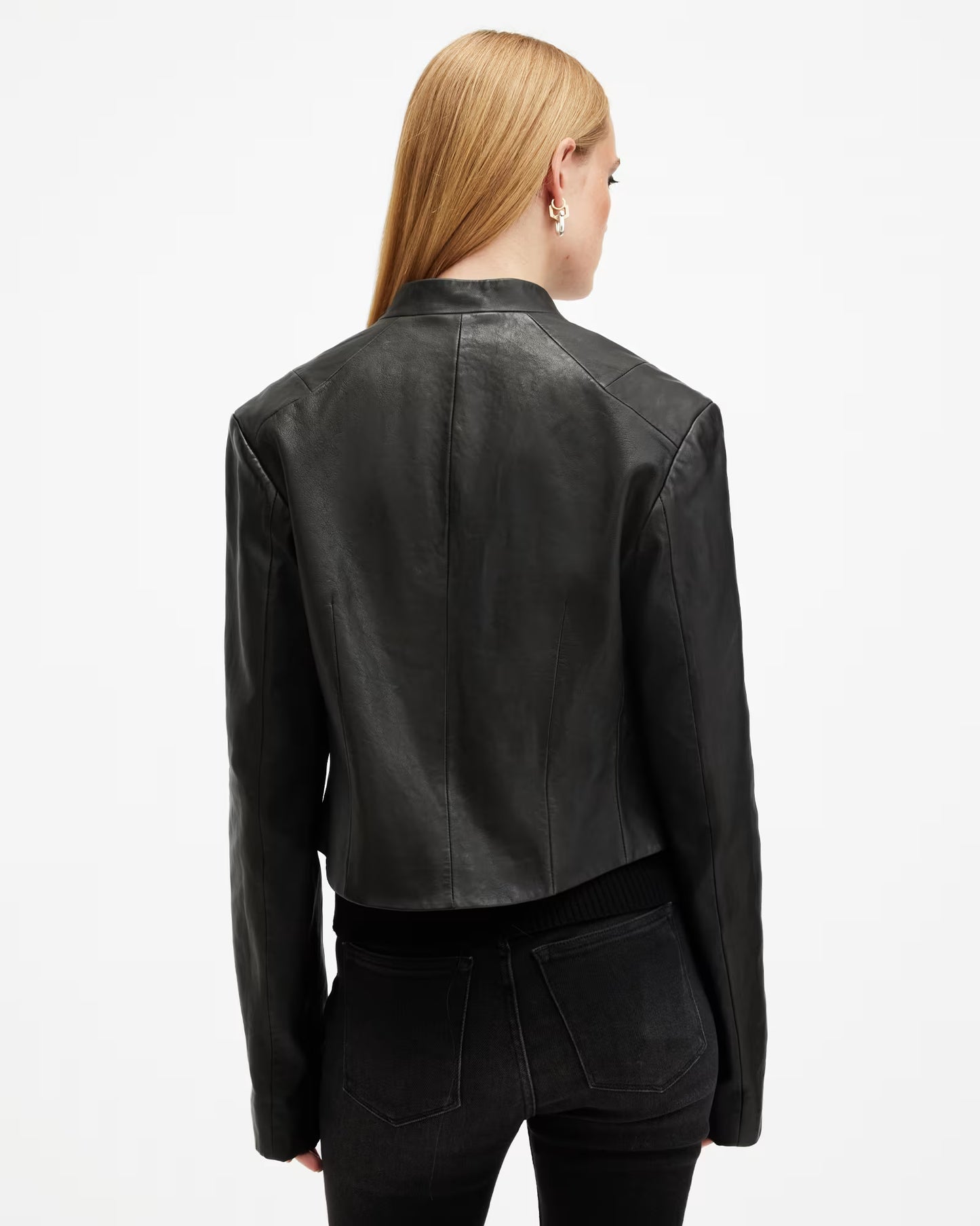 Person wearing a black leather jacket on a white background