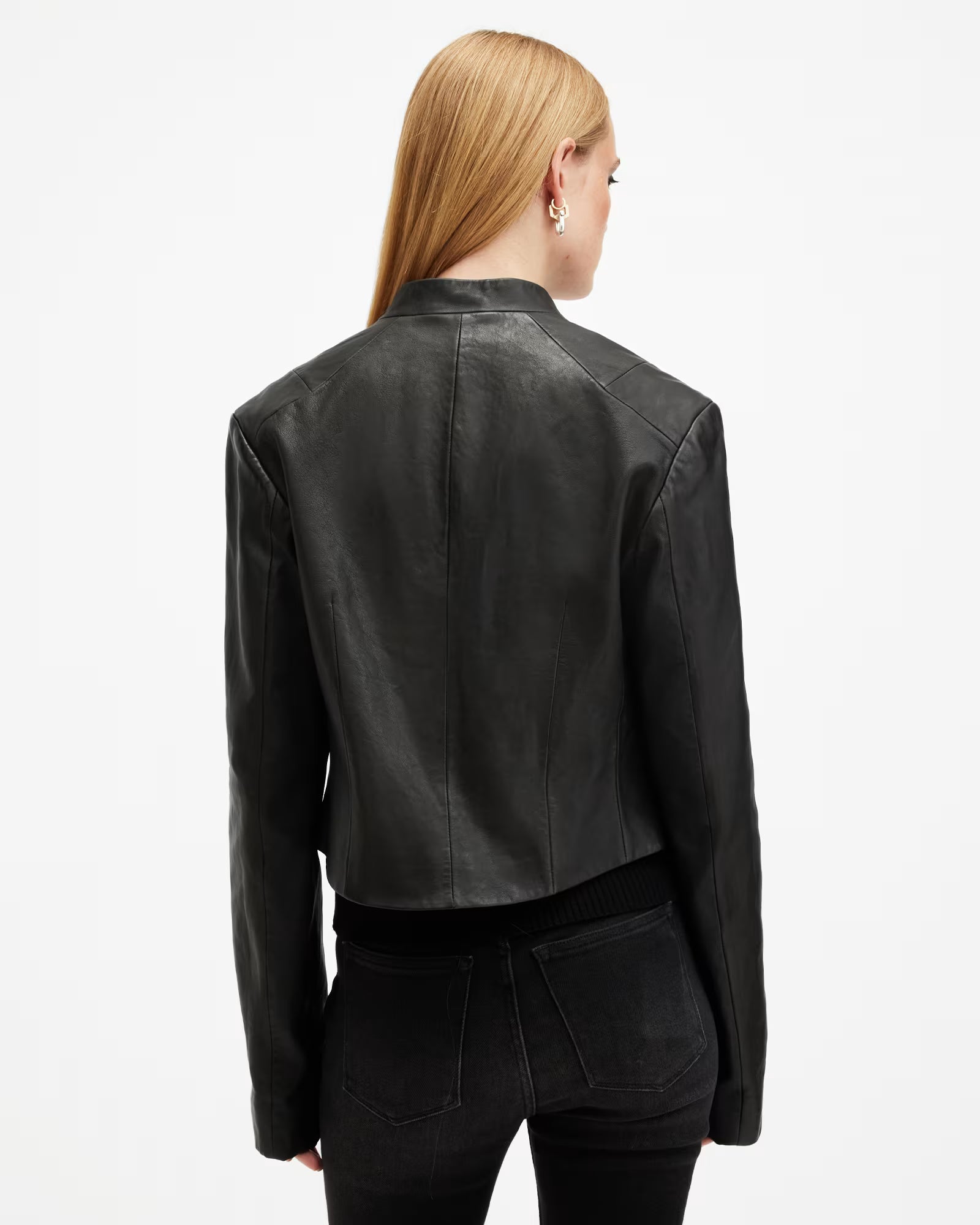 Person wearing a black leather jacket on a white background