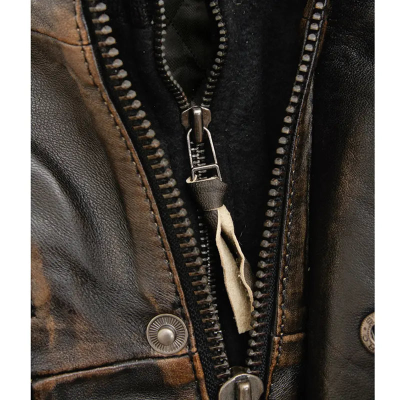 Close-up of a brown leather jacket with a zipper