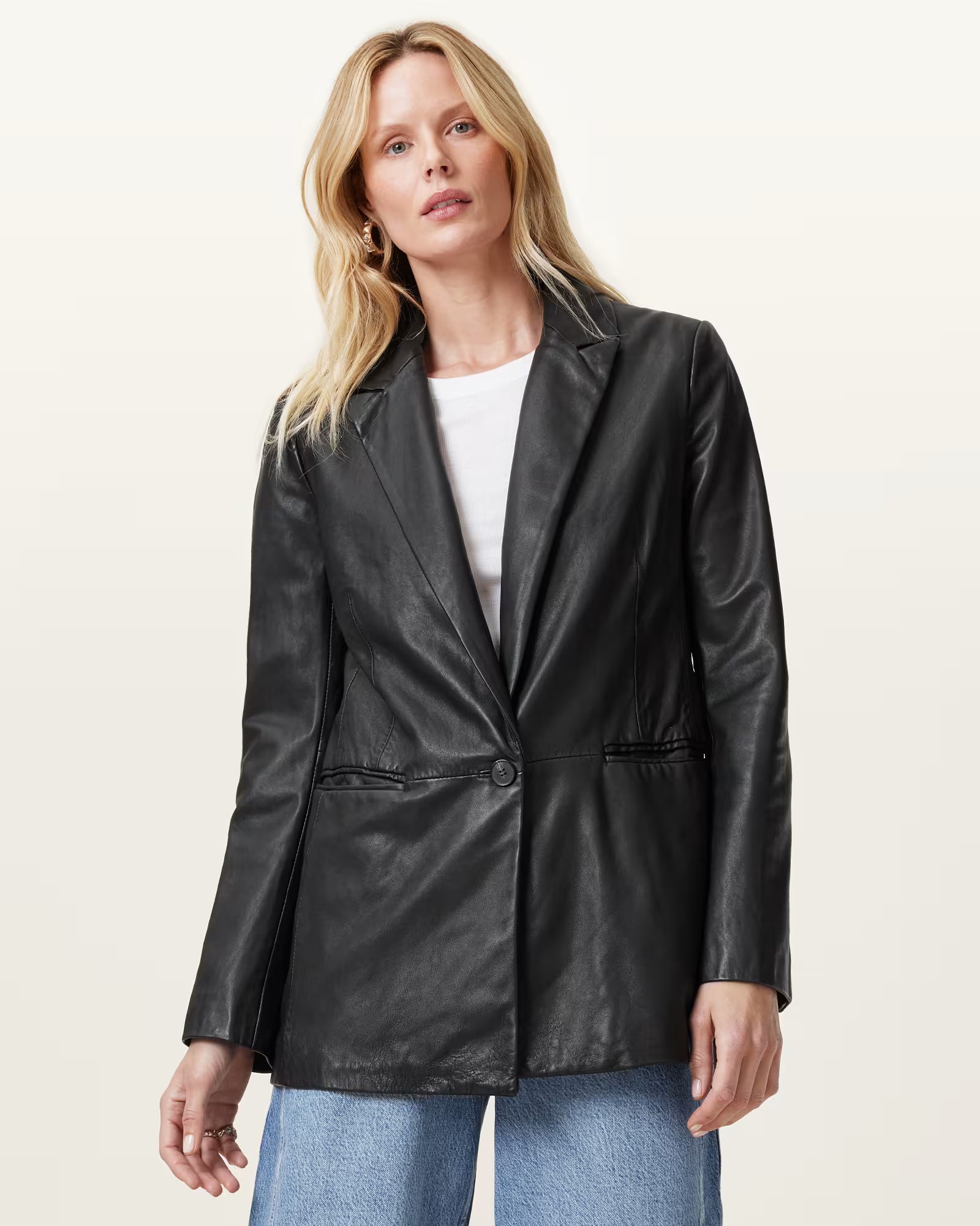 Woman wearing a black leather jacket on a white background