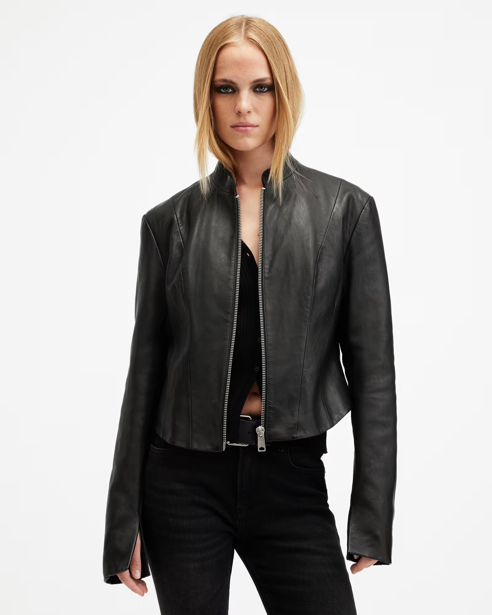 Woman wearing a black leather jacket on a white background