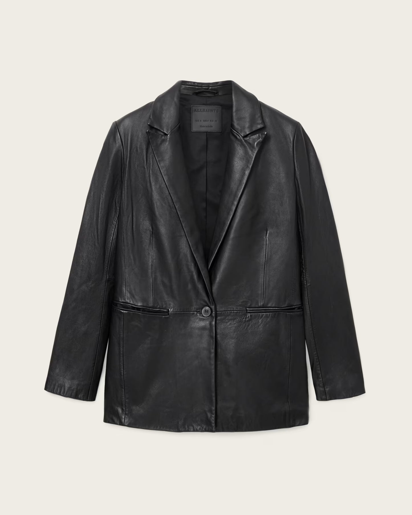 Black leather jacket on a light beige background