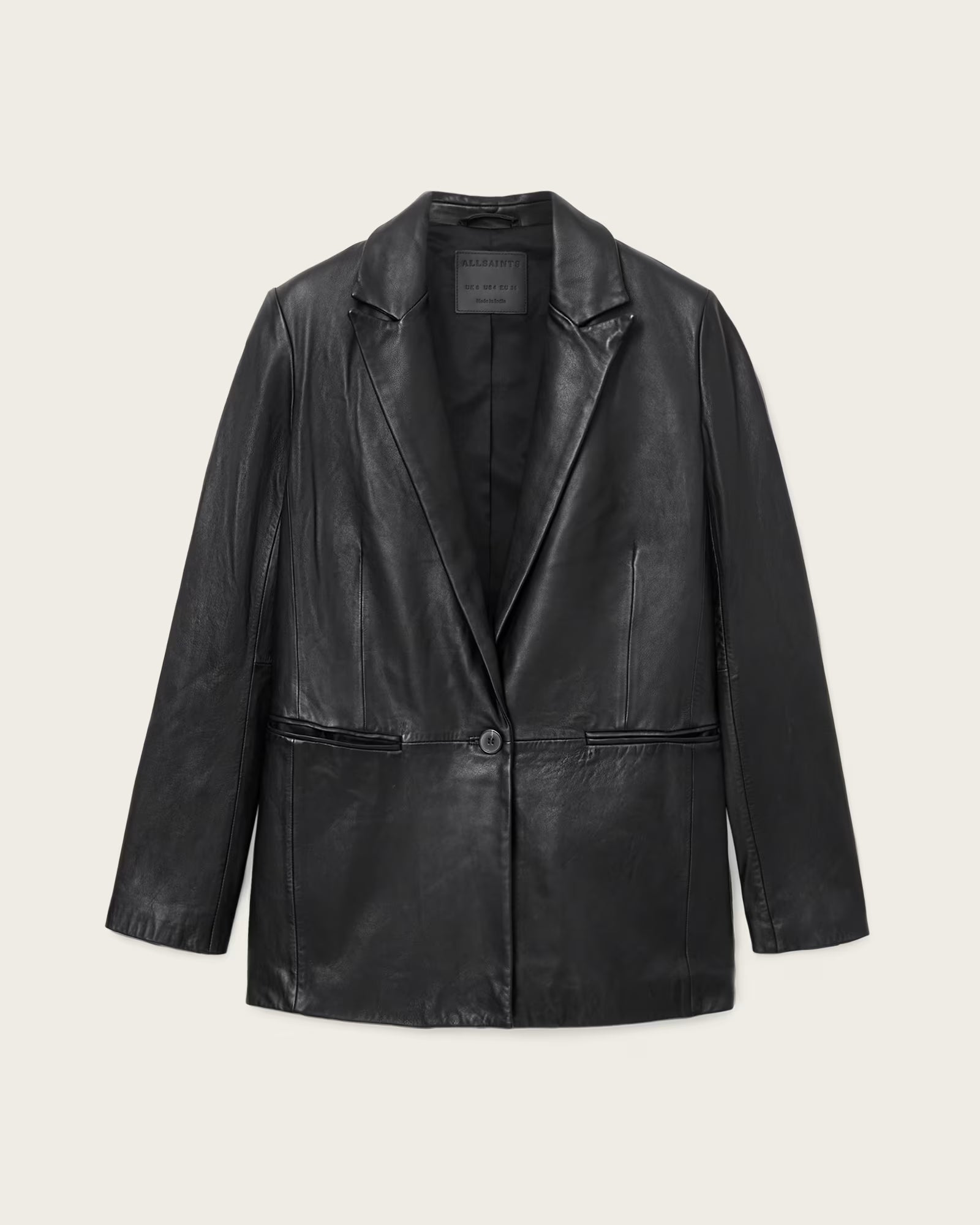Black leather jacket on a light beige background