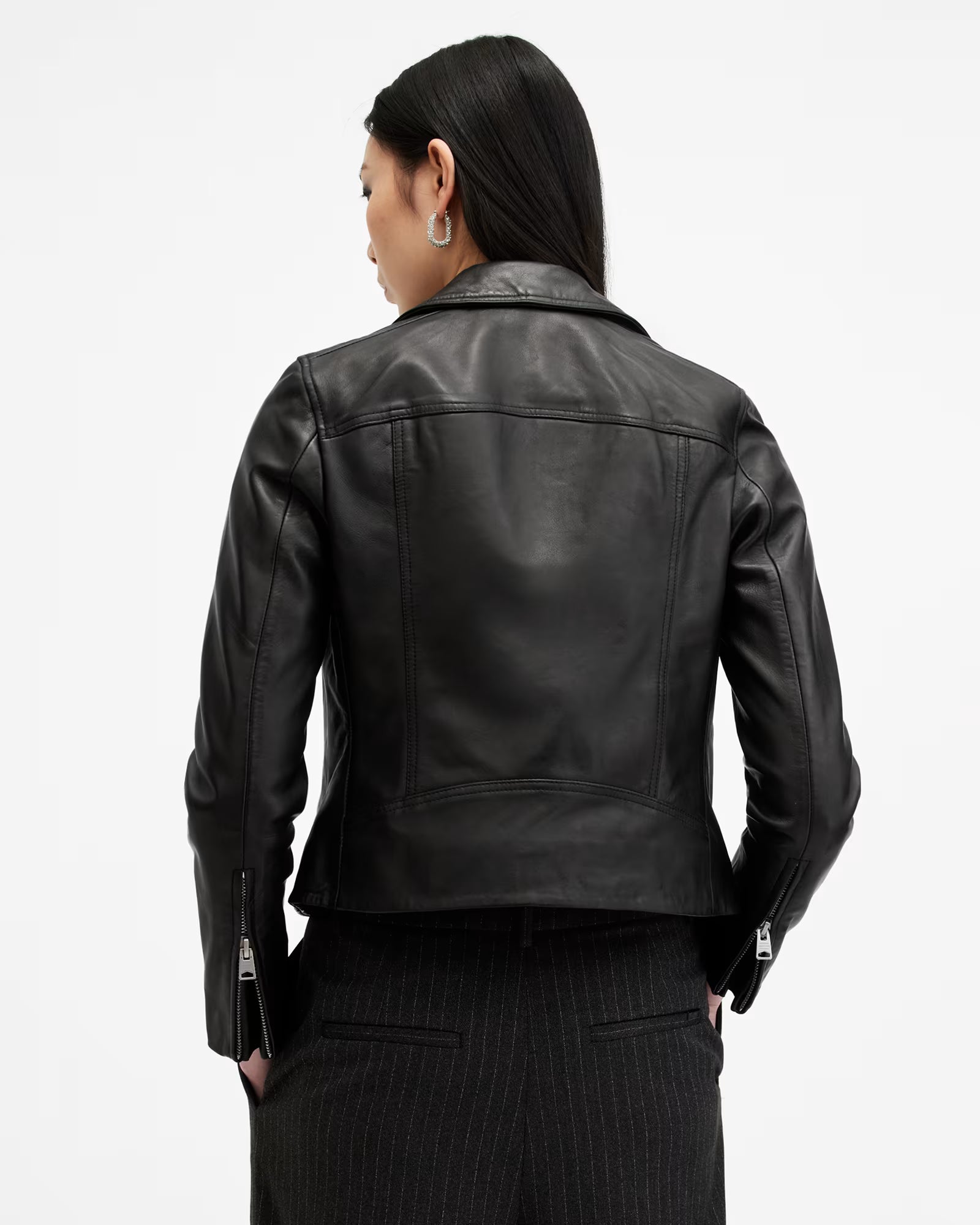 Black leather jacket worn by a person on a white background