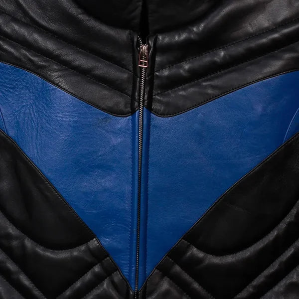 Close-up of a black and blue leather jacket with a zipper.