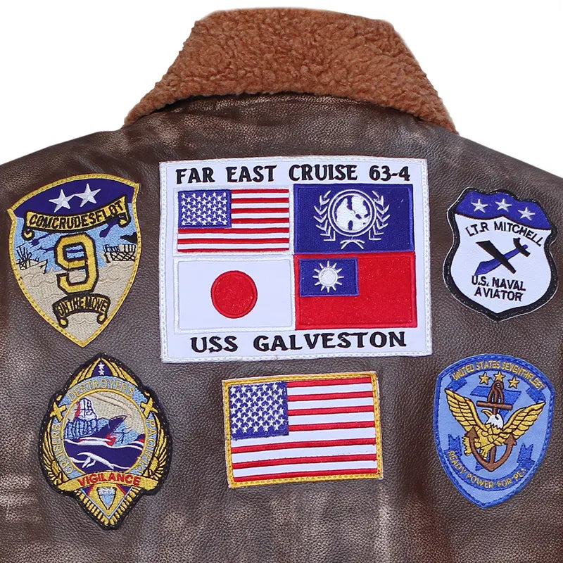 Brown jacket with various patches including USS Galveston and American flags.