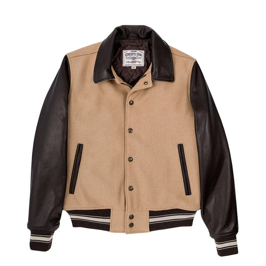 Beige jacket with black leather sleeves on a white background
