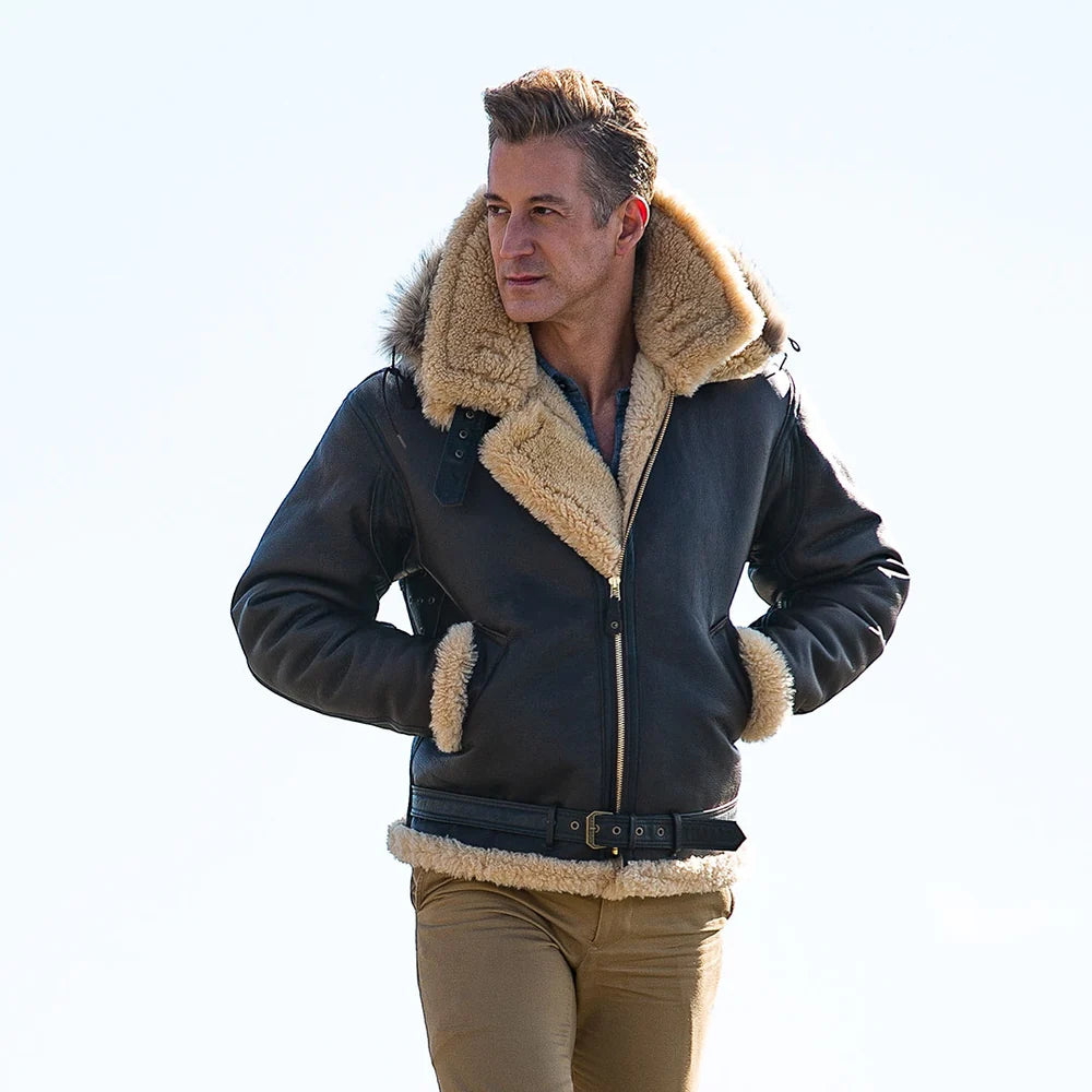Man wearing a black leather jacket with beige fur trim on a white background